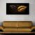Black and gold leaf wall art canvas displayed above gold sofa in modern living room