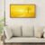 Golden yellow minimalist landscape canvas framed above beige sofa in modern living room