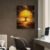 Golden glowing tree canvas art displayed above desk in modern office setting