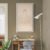 WE Minimal Line Art Buddha Wall Art with Lotus Halo - Zen Meditation Artwork 03 Zen Buddha line art wall decor displayed above desk in modern workspace interior.