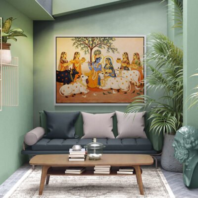 Framed Radha Krishna with sacred cows Pichwai artwork displayed above a green sofa in a modern living room interior.