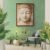Stone Buddha meditation wall art displayed in modern green interior with plants.