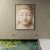 Minimal Buddha meditation wall art displayed above reflective water feature in Zen inspired space.