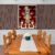 Shreenathji Pichwai wall art displayed above wooden dining table in traditional interior.